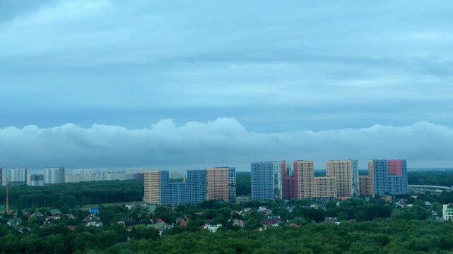 Dramatic timelapse of Moscow city view with PIK Salaryevo Park residential complex. Modern apartment buildings and real estate development under cloudy sky.