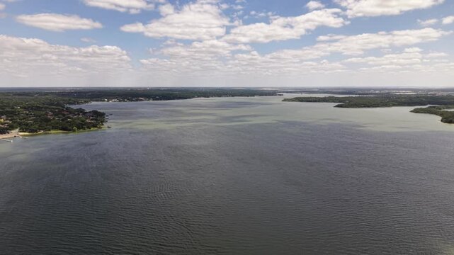 Drone Pulling Back Over Mountain Creek Lake in Arlington Texas
Cinematic drone footage flying backward over Mountain Creek Lake near Arlington, Texas. The camera gradually pulls away, revealing the ex