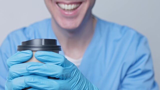 Smiling male doctor holding a coffee cup