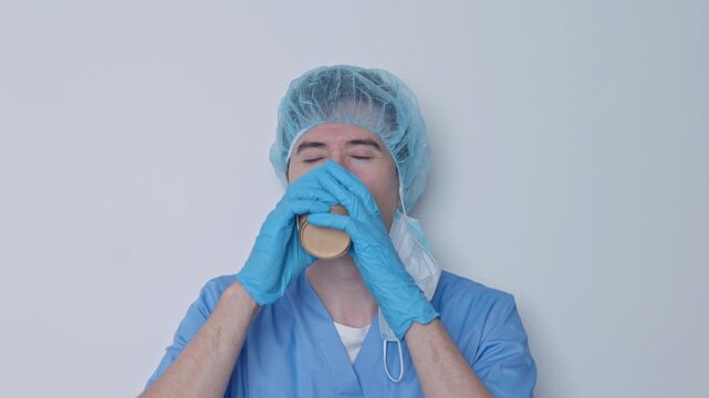 Exhausted male doctor enjoying a hot coffee break