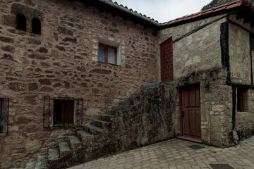 Fototapeta premium Traditional stone house facade with exterior stairs