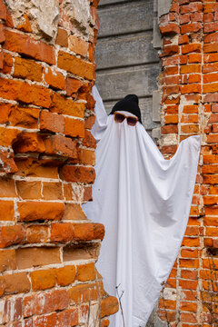 Ghost in costume amidst autumn brick ruins