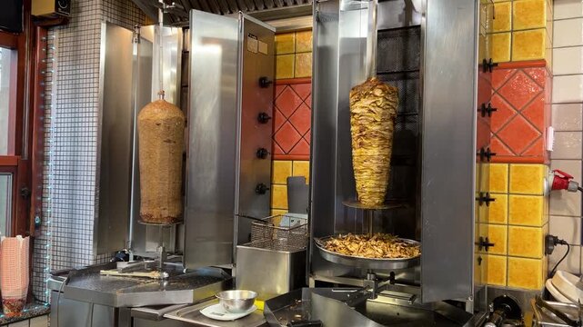 Shawarma, doner kebab. Vertical grill roaster with veal, chicken, and lamb. Grilled meat rotates, how to make shawarma.