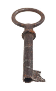 Old rusty key isolated on white background.