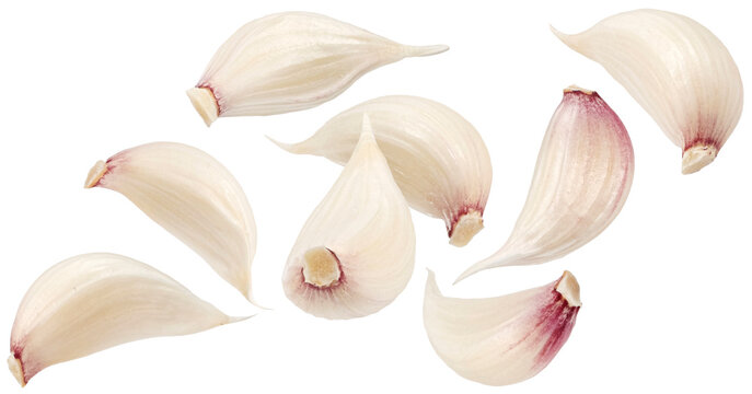 Falling garlic cloves isolated on white background