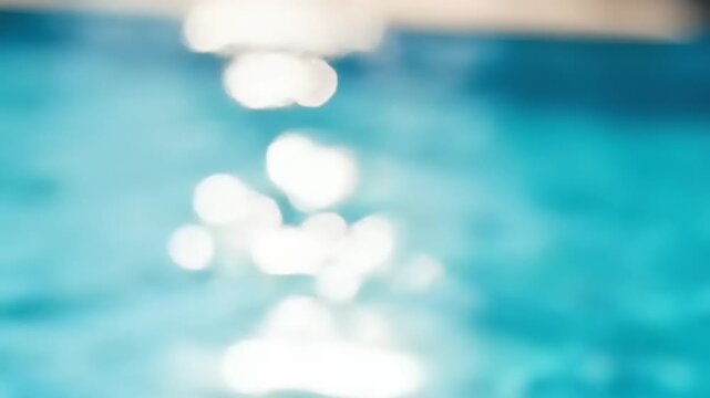 Blurry sunlight reflecting on blue water.