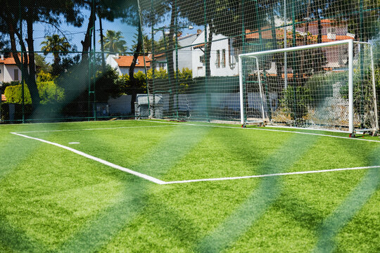 Football field with goal net on sunny day
