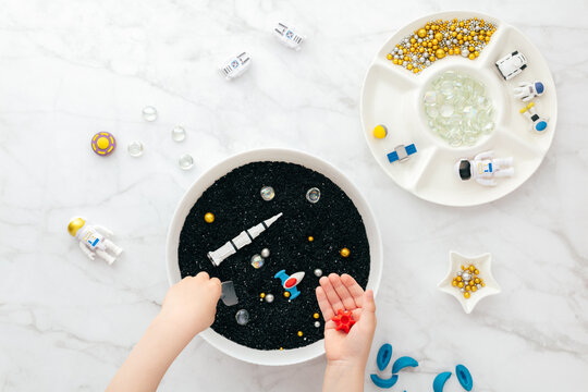 Montessori sensory bin space play for fine motor STEM