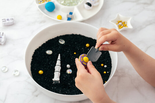 Montessori sensory bin for astronomy STEM tactile play