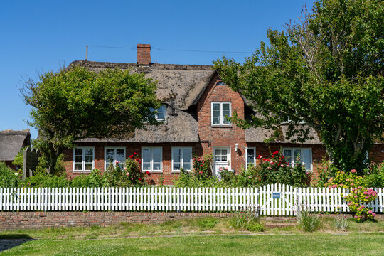 Traditional thatched-roof brick house on Langene&szlig; Hallig in Germany