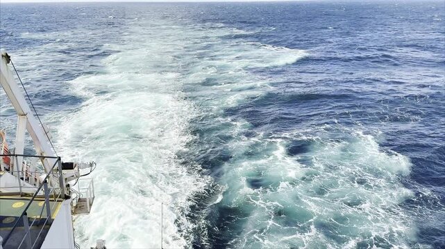 astern of ship at sea. keel jet maked by vessel propeller. unstoppable