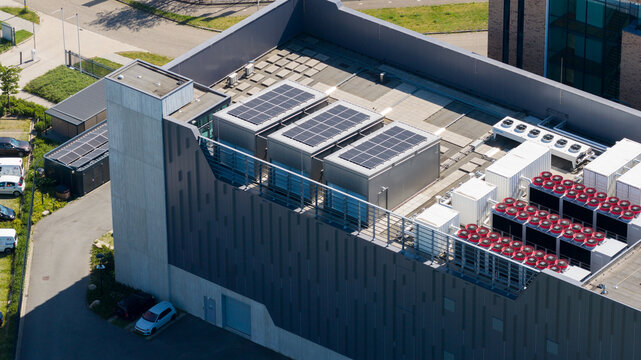 Aerial view of the Interconnect Services BV data center roof featuring solar panels and industrial cooling units in s-Hertogenbosch, Noord-Brabant, Netherlands.