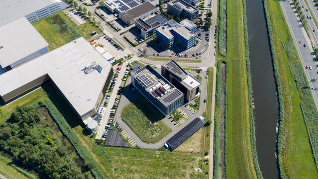 Aerial view of the Interconnect Services BV data center complex with office buildings, solar panels, and parking facilities 's-Hertogenbosch, Noord-Brabant, Netherlands.