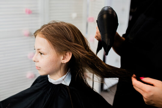 Teen getting hair dried at beauty salon