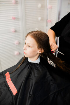 Teen having hair trimmed at a beauty salon