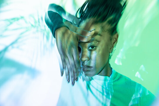 Portrait of afro woman dancer with hand pose and light