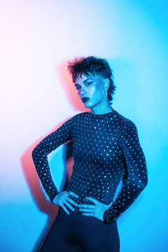 Cyberpunk young woman in neon light studio portrait