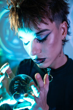 Cyberpunk young woman holding glowing orb in neon light
