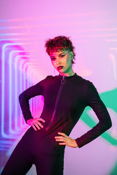 Cyberpunk young woman in neon light studio portrait