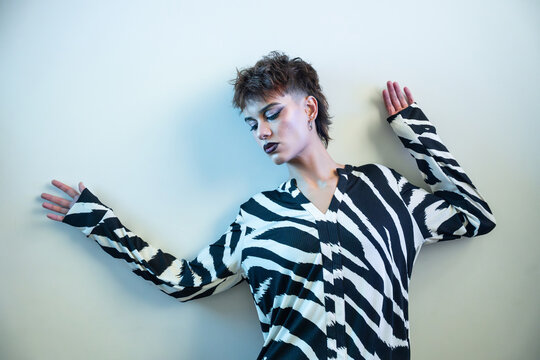 Young woman fashion model posing in zebra-print blouse