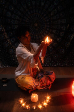 Spiritual Latin woman meditating with candlelight ritual