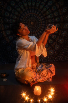 Spiritual Latin woman performing esoteric candle ritual