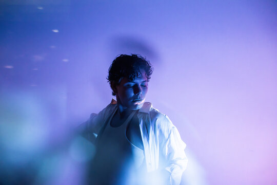 Mystic Latin woman in dreamy blue light and smoky haze