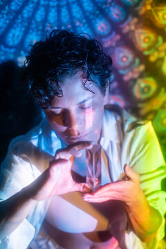 Latin woman holding crystal prism in mystical light