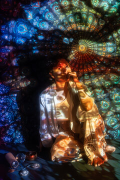 Spiritual Latin woman in mystical mandala light projection