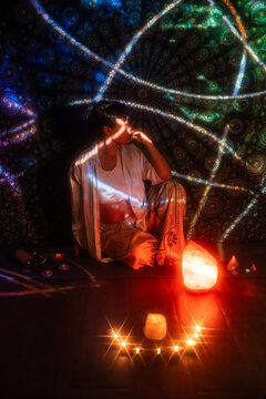 Spiritual esoteric Latin woman meditating with candlelight