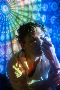Latin woman with crystal in mystic stained-glass light