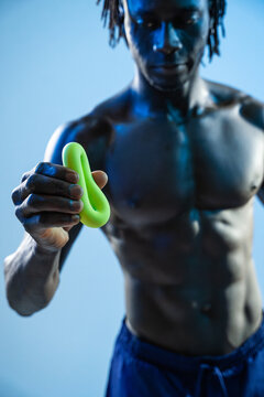 Black athlete holding resistance band in studio workout