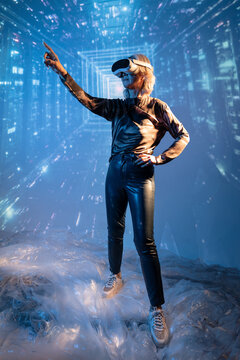 Futuristic senior Asian woman using VR in digital space