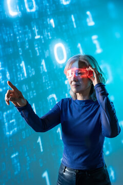 Futuristic senior Asian woman using AR glasses with data