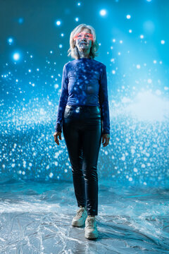Futuristic senior Asian woman in glowing digital space