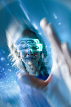 Futuristic senior Asian woman using glowing AR visor interface