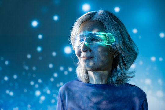 Futuristic senior asian woman with glowing ar visor