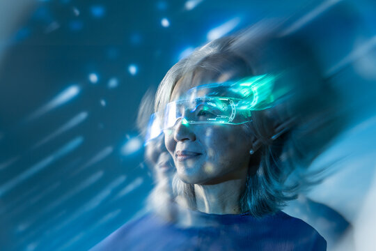 Futuristic senior Asian woman wearing glowing AR visor