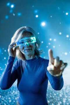 Futuristic senior Asian woman using glowing smart glasses