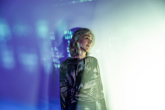 Futuristic senior Asian woman with holographic light
