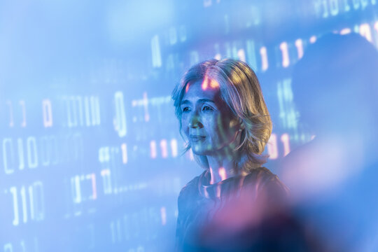 Futuristic portrait of Senior Asian woman in data light
