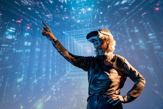 Futuristic senior Asian woman using VR in digital space