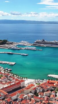 Drone view of Split harbor with boats ferries and nearby islands showing Adriatic maritime landscape.