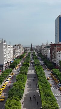 Avenue Habib Bourguiba in Tunis showing central city boulevard with urban traffic, architecture and daily life in Tunisia capital.