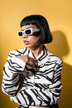 Stylish latin young woman in zebra jacket and sunglasses
