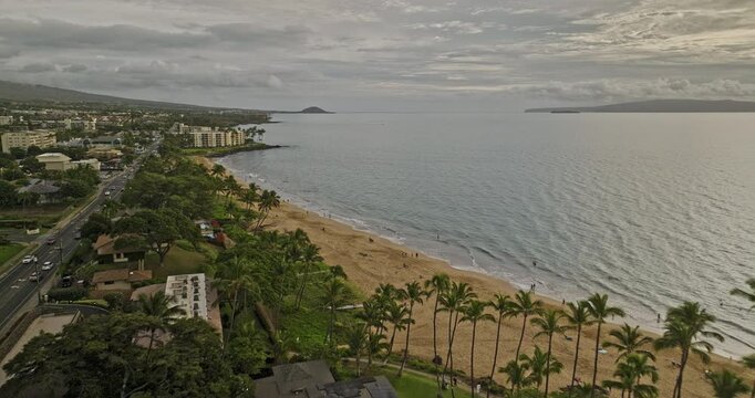 Kihei Maui Hawaii Aerial v3 drone flyover scenic Kamaole Beach Park towards Wailea capturing golden sandy beach, calm waters and seaside condos at sunset - Shot with Mavic 3 Cine - December 2022