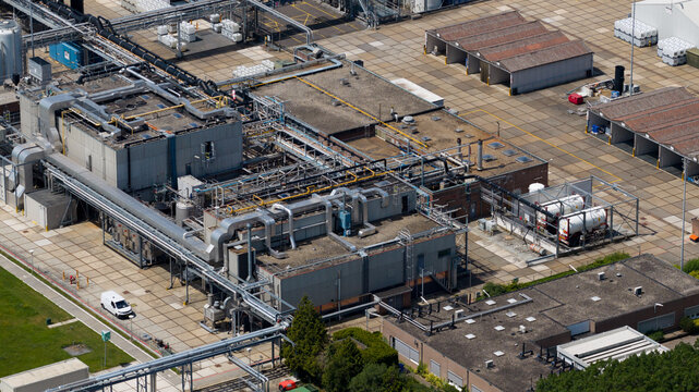 Aerial view of the Seqora B.V. industrial facility featuring complex piping systems, flat-roofed buildings, and storage tanks in Zaltbommel, Gelderland, Netherlands.