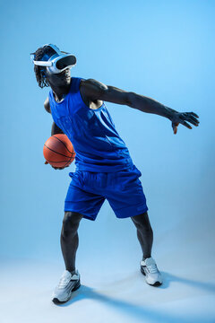Black basket man wearing VR headset holding basketball