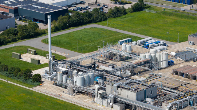 Aerial view of the Seqora B.V. industrial facility featuring storage tanks, complex piping systems, and surrounding green fields in Zaltbommel, Gelderland, Netherlands.