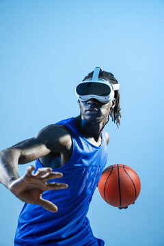 Black basketball player using VR headset with ball